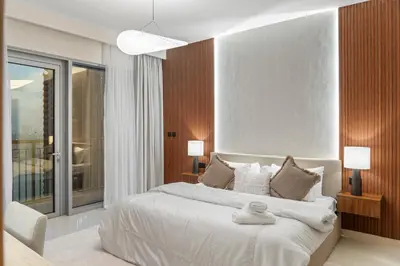 a bedroom with a large bed and a large window at Luxury Apartment - Burj Khalifa, Creek - Best View in Dubai