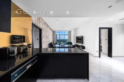 an open living room with a black counter top at Apartments at Millennium Atria, Business Bay in Dubai