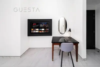 a desk with a mirror and a chair in a room at Apartments at Millennium Atria, Business Bay in Dubai