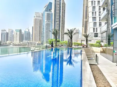 a swimming pool in a city with tall buildings at High-Floor 3BR with Balcony Overlooking the Marina, Near the Beach, Just Minutes Walk to the Tram, Damac Heights, Dubai Marina by Deluxe Holiday Homes in Dubai