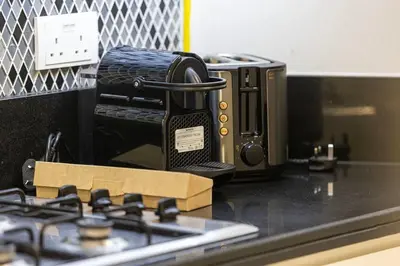 a toaster oven sitting on top of a kitchen counter at Premium 3BR Paramount Hotel Midtown Business Bay in Dubai