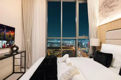 a bedroom with a large window with a city view at Spacious 4BR for 12 Burj View PS5 Dubai Mall in Dubai