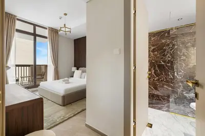 a hotel room with a bed and a bathroom at Brand New 1BR Near Metro at Avenue Residence in Dubai