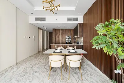 a kitchen with a table and two chairs at Brand New 1BR Near Metro at Avenue Residence in Dubai