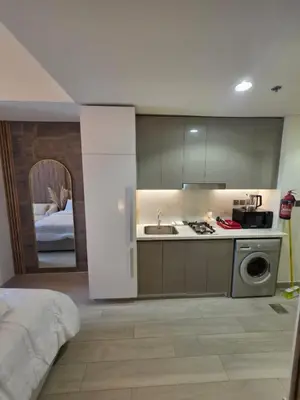 a kitchen with a sink and a stove top oven at Luxury Studio With Burj Khalifa Views in Dubai