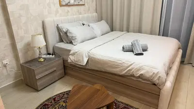a bedroom with a bed with two towels on it at Luxury Studio with Pool Views in Dubai