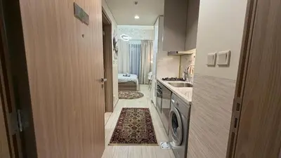 a small kitchen with a washing machine and a sink at Luxury Studio with Pool Views in Dubai