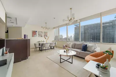 a living room with a couch and a table at Silkhaus Expansive 2BDR in DIFC Sky Gardens in Dubai