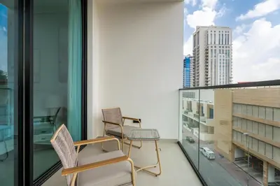 two chairs on a balcony with a view of a city at GuestReady - Spacious 1 bedroom apartment in Dubai