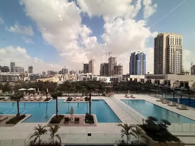 a large pool with a city in the background at GuestReady - Spacious 1 bedroom apartment in Dubai