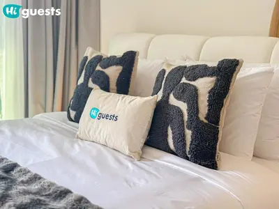 a white couch with six pillows on it at HiGuests - Dubai Skyline Studio with Premier Views in Dubai