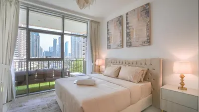 a bedroom with a large bed and a large window at Deluxe Pool View apartment in BLVD Crescent Downtown Dubai by Norbu Holiday Homes in Dubai