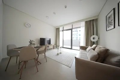 a living room with a couch and a table at Elegant 1BR with Balcony in West Five Business Bay in Dubai
