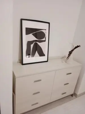 a white dresser with a picture on top of it at Elegant 1BR with Balcony in West Five Business Bay in Dubai
