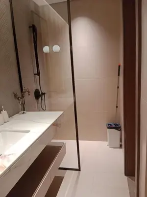 a bathroom with a shower and a white sink at Elegant 1BR with Balcony in West Five Business Bay in Dubai