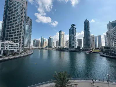 a river in the middle of a city with tall buildings at Frank Porter - Liv Residence in Dubai