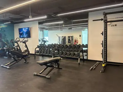 a gym with several treadmills and exercise bikes at Frank Porter - Liv Residence in Dubai