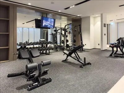 a gym with several treadmills and tread machines at Luxury Burj Khalifa View Downtown Residence at Burj Vista Apartment in Dubai