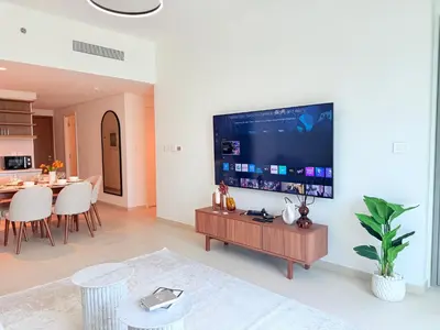 a living room with a large flat screen tv on a wall at Luxury Burj Khalifa View Downtown Residence at Burj Vista Apartment in Dubai
