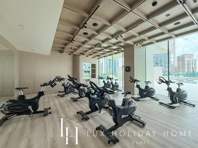 a gym with a bunch of exercise bikes in a room at LUX The Phantom Sky Pool Suite in Dubai