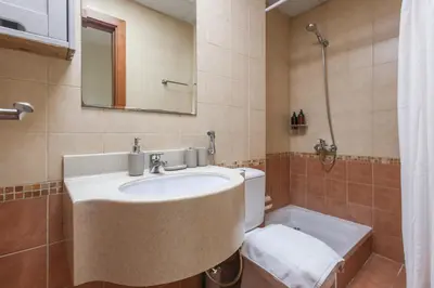 a bathroom with a sink and a toilet and a mirror at Bright 2BR in Dubai Marina - Close to beach in Dubai