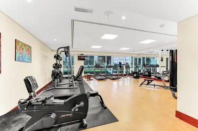 an exercise room with a gym with a treadmill at Waves - Modern Lakeview Studio - Cozy & Bright in Dubai