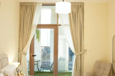 a living room with a sliding glass door at Luxury Brand New 2 BR Apartment Burj & Canal View Business Bay Dubai in Dubai