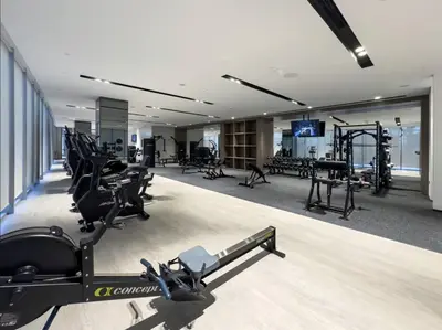 a gym with treadmills and exercise equipment in a building at Burj Vista Luxury Apartments with Burj Khalifa View in Dubai