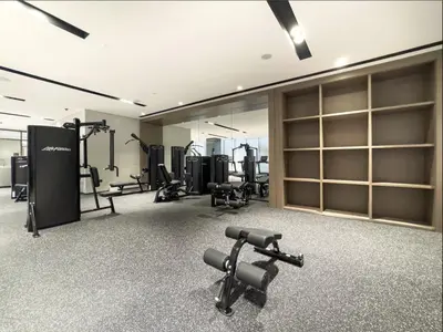 a gym with treadmills and machines in a room at Burj Vista Luxury Apartments with Burj Khalifa View in Dubai
