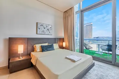 a bedroom with a bed and a large window at Burj Vista Luxury Apartments with Burj Khalifa View in Dubai