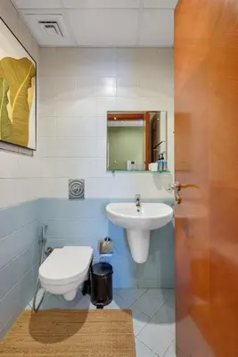 a bathroom with a toilet and a sink at JLT Cozy and Modern 1BR Pool and Gym Walk to Metro in Dubai