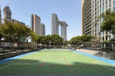 a tennis court in the middle of a city at Burj Vista Modern Comfort - 1BR with Pool, Gym and Scenic views in Dubai