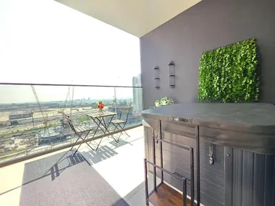 a living room with a bar and a large window at Trillionaire Bayhouse Chic Studio - Jacuzzi with views, Pool and Gym in Dubai