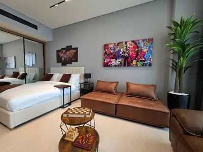 a bedroom with a bed and a couch at Trillionaire Bayhouse Chic Studio - Jacuzzi with views, Pool and Gym in Dubai