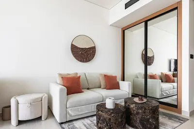 a living room with a couch and a table at The Trillionaire Bayhouse - Private Jacuzzi, Sauna, pool and gym in Dubai