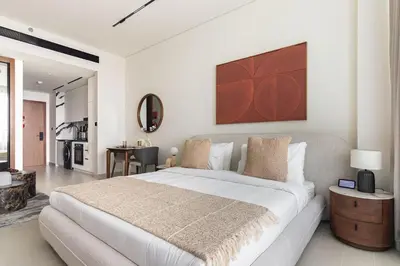 a bedroom with a large bed and a living room at The Trillionaire Bayhouse - Private Jacuzzi, Sauna, pool and gym in Dubai
