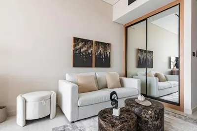 a living room with a couch and a table at Trillionaire Bayhouse One- Private Jacuzzi, Sauna, pool and gym in Dubai