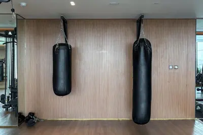 two black punching bags hanging on a wall at Trillionaire Bayhouse One- Private Jacuzzi, Sauna, pool and gym in Dubai