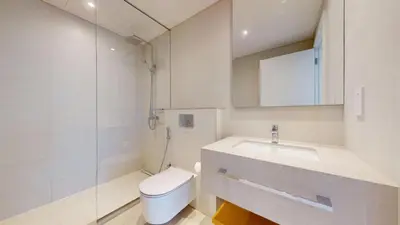 a white bathroom with a toilet and a sink at Vacationer l Chic 2 Bedroom l Sea Views l Private Beach Access in Dubai
