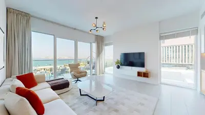 a living room with a couch and a tv at Vacationer l Chic 2 Bedroom l Sea Views l Private Beach Access in Dubai