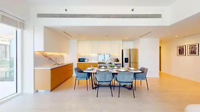 a kitchen and dining room with a table and chairs at Vacationer l Chic 2 Bedroom l Sea Views l Private Beach Access in Dubai