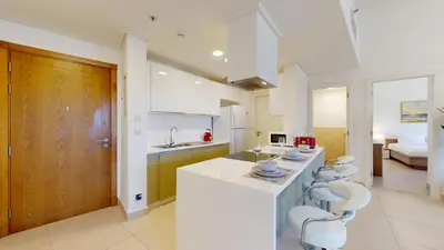 a kitchen with white counters and white appliances at Vacationer l Cozy 1 Bed l Jumeirah Golf Estate l Free Pool, Gym in Dubai