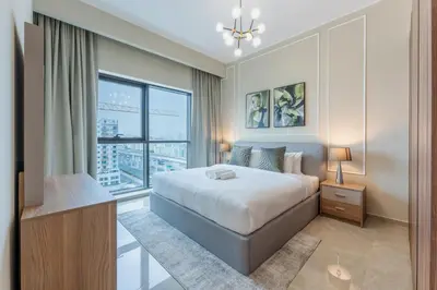 a bedroom with a bed and a large window at Vacationer l Elegant 1 Bed l Next to Metro l Near Mall in Dubai