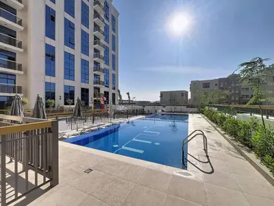 a swimming pool in the middle of a building at Vacationer l Elegant 1 Bed l Next to Metro l Near Mall in Dubai