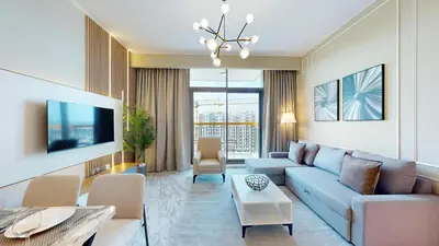 a living room with a couch and a tv at Vacationer l Elegant 1 Bed l Next to Metro l Near Mall in Dubai