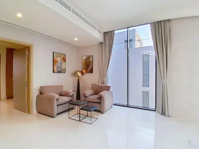 a living room with two chairs and a table at Vacationer l Breathtaking 5 Bed Villa l Luxurious & Spacious in Dubai