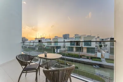 a balcony with a table and chairs and a view of a city at Vacationer l Breathtaking 5 Bed Villa l Luxurious & Spacious in Dubai