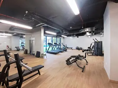 a gym with several treadmills and exercise bikes at Vacationer l Peaceful Studio l Circle Mall l Greenery Community in Dubai