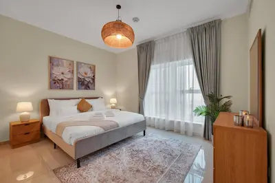a bedroom with a bed and a large window at Business Bay 1 BR on Canal 7 min to Dubai Mall in Dubai