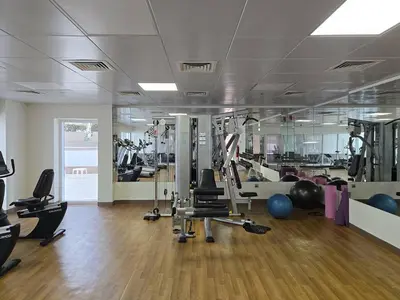 a gym with lots of treadmills and exercise equipment at Business Bay 1 BR on Canal 7 min to Dubai Mall in Dubai